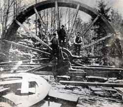 Vattenhjulet Konstahjulet vid Kronobergets gruvfält med tre män. Hjulet revs 1916. - klicka f�r att f�rstora